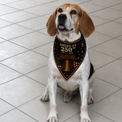 Dog wearing a bandana with 'America's 250th' text and bell design on a tiled floor.